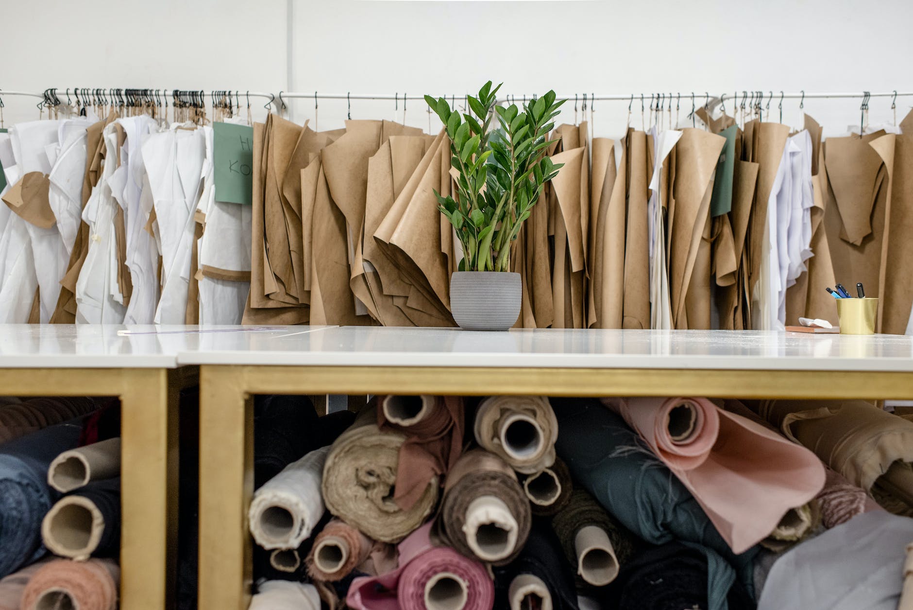 rolls of assorted fabrics and textiles and sewing patterns inside tailor atelier - lifestyle changes for hormonal imbalnaces